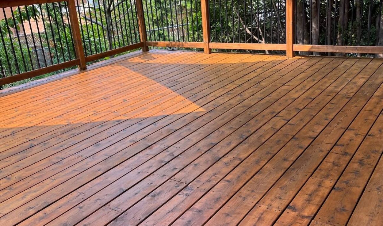 Lightly stained wooden deck with a clean, even finish, exemplifying Fit Painting's expert deck staining services in Kitchener-Waterloo.